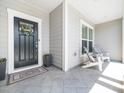 Inviting front porch with stylish tile flooring and comfortable seating at 1121 Coast Grade St, Wake Forest, NC 27587