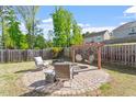 Backyard with a seating area and hanging chairs, perfect for outdoor relaxation at 114 Red Robin Rd, Durham, NC 27703