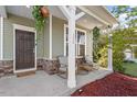Charming front porch with seating, decorative plants, and a welcoming entrance at 114 Red Robin Rd, Durham, NC 27703