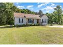Well-maintained one-story home with large front yard, mature trees and welcoming curb appeal at 116 Meade Dr, Four Oaks, NC 27524