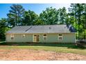 The back of the house with large windows and a sliding glass door at 116 Shawnee Dr, Louisburg, NC 27549