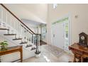 Bright foyer with tiled floor, staircase, and white front door at 1204 Caribou Xing, Durham, NC 27713
