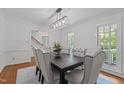 Elegant dining room with hardwood floors, decorative chandelier, and a table with upholstered chairs at 128 Cobblestone Dr, Chapel Hill, NC 27516