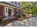 Inviting front entrance with brick steps and decorative flower pots, offering curb appeal at 1506 Ephesus Church Rd, Chapel Hill, NC 27517