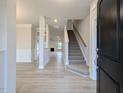 Bright entryway featuring modern flooring, staircase, and open floor plan leading to living area at 1590 Pecan Drive # 45, Nashville, NC 27856
