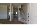 View of the home's foyer, featuring stairs and molding, leading to the living room and other living spaces at 1590 Pecan Drive # 45, Nashville, NC 27856
