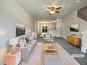 Stylishly staged living room with neutral tones, plush carpet, and an open floor plan for modern living at 1610 Oxleymare Dr, Raleigh, NC 27610