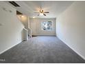 Bright living room with neutral carpet, large window and a staircase leading to the upper level at 1610 Oxleymare Dr, Raleigh, NC 27610