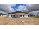 Rear view of new home showcasing a covered patio, windows, and vinyl siding at 1635 Pecan Drive # 26, Nashville, NC 27856