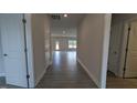 Spacious hallway with hardwood flooring, neutral paint, and white doors at 1635 Pecan Drive # 26, Nashville, NC 27856