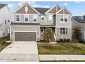 Beautiful two-story home featuring a two-car garage, well-maintained lawn, and stone accents on the facade at 1816 Sandoval Dr, Durham, NC 27703