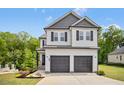Charming two-story home featuring a two-car garage and a welcoming facade at 185 Millwood Dr, Clayton, NC 27527