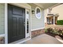 Charming front door with sidelight and transom, complemented by stone accents at 201 Mayfield Dr, Apex, NC 27539