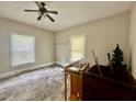 Bedroom featuring a ceiling fan, neutral walls, and two windows providing natural light at 211 Webb St, Roxboro, NC 27573