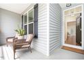 Inviting front porch with comfortable seating and views to the home's interior at 275 N Farm Dr, Clayton, NC 27527