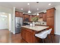 Modern kitchen featuring an island with granite countertops and stainless steel appliances at 275 N Farm Dr, Clayton, NC 27527