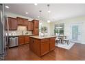 Spacious kitchen featuring an island, stainless steel appliances, and a dining area at 275 N Farm Dr, Clayton, NC 27527
