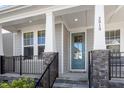 Inviting front porch featuring stone accents, providing a cozy outdoor seating area at 2919 Winter Crop Way, Apex, NC 27502
