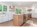 This spacious kitchen features a wooden island, stainless appliances, and light countertops at 3009 Hillmer Dr, Raleigh, NC 27609