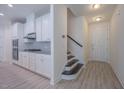 Inviting entryway with stairs, and a view into the modern kitchen at 311 Alamosa Pl, Cary, NC 27519