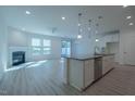 Bright living space with modern floors, fireplace, and sliding glass doors to the backyard at 311 Alamosa Pl, Cary, NC 27519