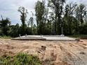 New home foundation on a wooded lot, showcasing the initial stages of construction and serene surroundings at 327 Bishop Ln, Sanford, NC 27330
