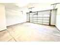 Clean, empty two-car garage featuring white walls and a concrete floor at 332 Bishop Ln, Sanford, NC 27330