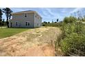 View of home's backyard showing land and proximity to undeveloped natural area at 356 Bishop Ln, Sanford, NC 27330