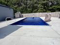Inviting in-ground pool with a slide and concrete surround, perfect for summer enjoyment at 3605 Mine Creek Rd, Burlington, NC 27217