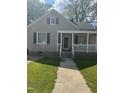 Charming single-story home with a welcoming front porch and well-maintained landscaping at 432 N Mercer N St, Rocky Mount, NC 27801