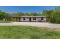 Charming home featuring a covered porch with rocking chairs, perfect for relaxing outdoors at 435 Salt And Light Ln, Henderson, NC 27537