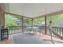 Relaxing screened-in porch with comfortable seating and a view of the serene backyard at 5144 Jeffries St, Raleigh, NC 27606