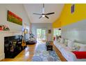 Airy living room with vaulted ceiling, fireplace, and sliding glass doors leading to a deck at 6 Chelan Ct, Durham, NC 27713