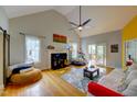 Spacious living room featuring hardwood floors, a fireplace, and sliding glass doors to the deck at 6 Chelan Ct, Durham, NC 27713