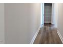 Hallway featuring wood-look floors and a linen closet for storage at 600 Sweet Potato Lane # 38, Nashville, NC 27856