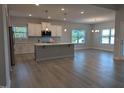 Open-concept kitchen featuring a large island, stainless appliances, and sleek countertops at 600 Sweet Potato Lane # 38, Nashville, NC 27856