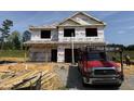 Exterior view of the home under construction with the frame partially completed at 606 Melrose Ct, Sanford, NC 27330
