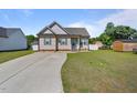 Charming single-story home boasts a manicured lawn, a concrete driveway, and classic curb appeal at 608 W Godwin St, Dunn, NC 28334