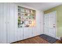 Entryway with built-in shelving and storage, and hardwood flooring at 708 W Main St, Carrboro, NC 27510