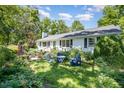 Inviting front yard featuring a lush green lawn, garden and outdoor seating at 708 W Main St, Carrboro, NC 27510
