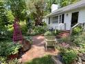 View of the front entrance, brick walkway, and front yard with garden at 708 W Main St, Carrboro, NC 27510
