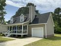 Attractive two-story home with a covered front porch and attached garage at 717 Papsworth Ct, Fuquay Varina, NC 27526