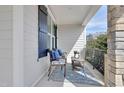 Cozy front porch with stylish seating, a patterned rug, and stone pillars at 100 Highveld Ave, Chapel Hill, NC 27516