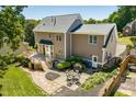 Spacious backyard featuring a deck, patio area with dining set, and lush landscaping at 10320 Crisp Dr, Raleigh, NC 27614