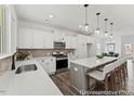 Bright kitchen featuring a center island, pendant lighting, stainless appliances and views to the dining room at 105 S Mule Way # 89, Benson, NC 27504