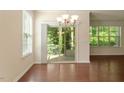 Bright dining area with hardwood floors and sliding glass doors leading to a patio at 1175 Contessa Dr, Cary, NC 27513