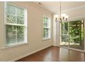 Bright dining area with hardwood floors and sliding glass doors leading to a patio at 1175 Contessa Dr, Cary, NC 27513