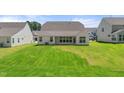 Large backyard with a covered patio and ample space for outdoor activities at 1306 Cricket St, Elon, NC 27244