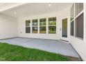 Covered patio with concrete floor and ample natural light and view of the backyard at 1306 Cricket St, Elon, NC 27244