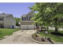 Traditional two-story home featuring an attached two-car garage, complemented by a well-maintained lawn and driveway at 133 Pasadena Rd, Garner, NC 27529